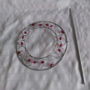 Round metal curtain tieback with red beads